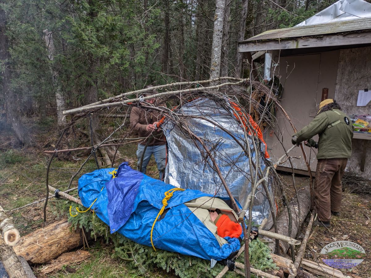 building an emergency shelter for an injured person on the Maine Guide Medic course