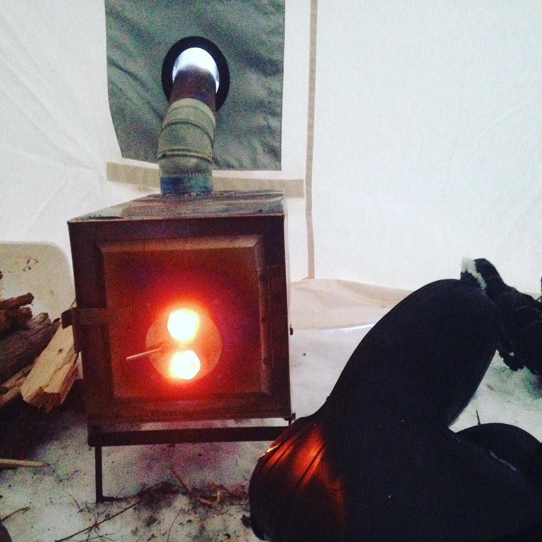 enjoying-the-warmth-of-the-expedition-tent-and-stove-at-the-end-of-a-long-day_24542585126_o